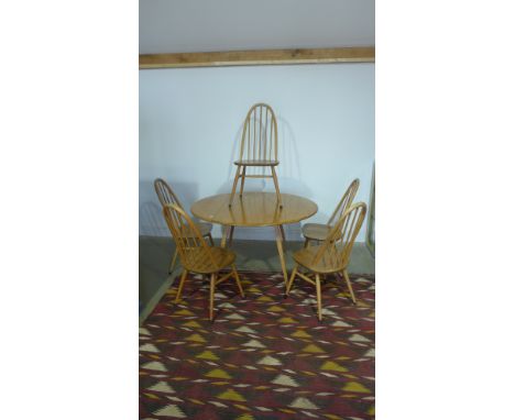 An Ercol golden elm drop leaf table with five single chairs - table height 72cm x 112cm x 123cm - some usage wear but overall