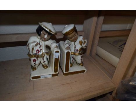 A pair of Oriental style ceramic book ends together with a section of wooly mammoth tusk (3)