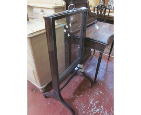 A late 19th/early 20th Century mahogany framed glazed firescreen 