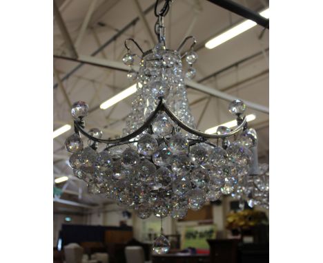 A 20th Century eight branch glass chandelier with drop pendants and another 