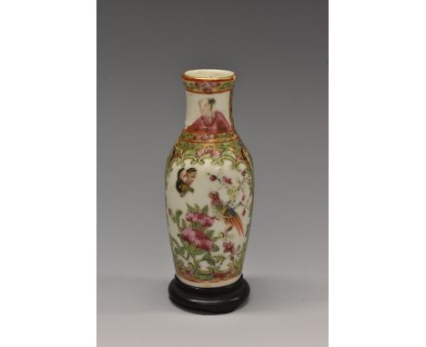 A small Chinese famille verte baluster vase, painted with figures in a stylized interior in a C-scroll reserve in colourful p