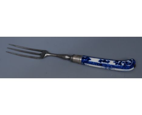 A Saint Cloud cutlery handle, pistol parrot grip, painted in underglaze blue with scrolls,  steel three pronged fork, 21.5cm 
