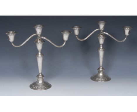 A pair of American silver three-light table candelabra, bell shaped sconces, reeded branches, knopped tapered stems, spreadin