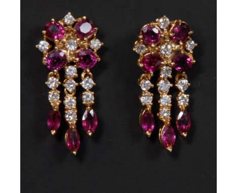 A pair of ruby and diamond chandelier earrings, each pave set with seven pinky red rubies and twelve round cut diamonds, tota