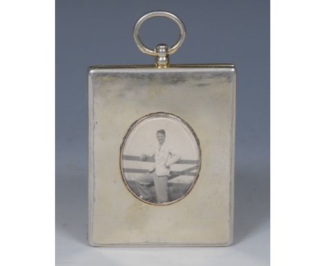 An early Victorian silver-gilt travelling portrait miniature case, hinged cover centred by an oval aperture, enclosing a phot