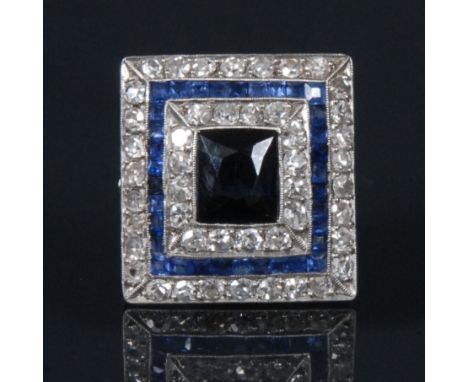 An Art Deco style blue and white sapphire rectangular panel ring, central blue sapphire surrounded by three alternating stepp