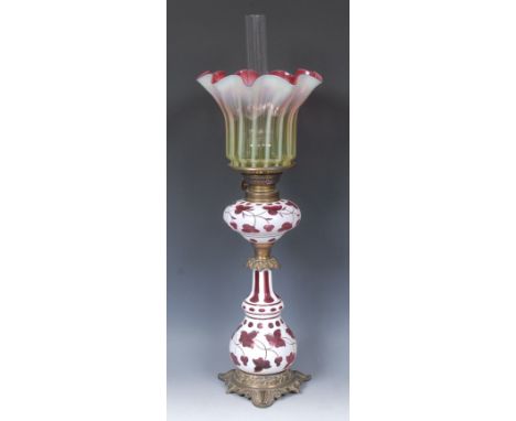 A 19th century Bohemian opaque overlaid cranberry glass table oil lamp, frilled vaseline shade, Duplex-type burner, the reser