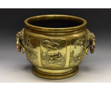 A large Japanese jardiniere, the sides with six shaped panels embossed with storks, phoenix, ducks and other birds, stylised 