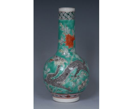 A Chinese porcelain globular bottle vase, painted with a ferocious dragon in tones of sallow, red, black and grey, pursuing a