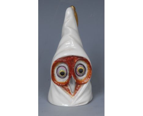 A Royal Worcester candle snuffer, of a wise owl, wearing a pointed cap, with gilt tassel, 8cm high, printed crown and circle 