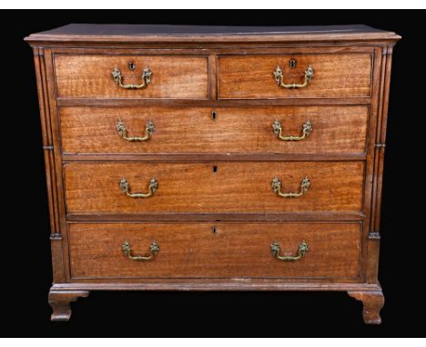 A well figured George III mahogany chest of two short and three long graduated cockbeaded drawers, moulded top, Gothick clust