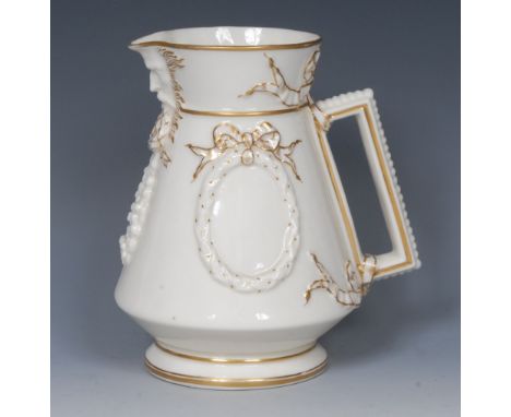 A Belleek angular jug, in relief with ribbon tied laurel wreaths mask to spout, angular handle, 16cm high, first period black