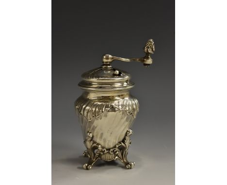 A 19th century French Rococo Revival silver spirally fluted bombe shaped pepper grinder, acanthus scroll feet, 11cm high, c.1