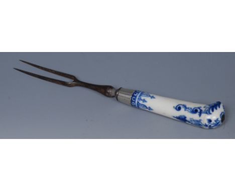 A Saint Cloud cutlery handle, pistol parrot grip, painted in underglaze blue with scrolls,  steel two pronged fork, 21cm long