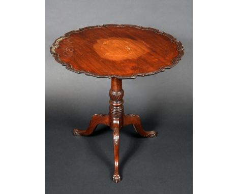 A 19th century mahogany shaped circular tripod supper table, tilting top with pie crust border, turned column, cabriole legs 