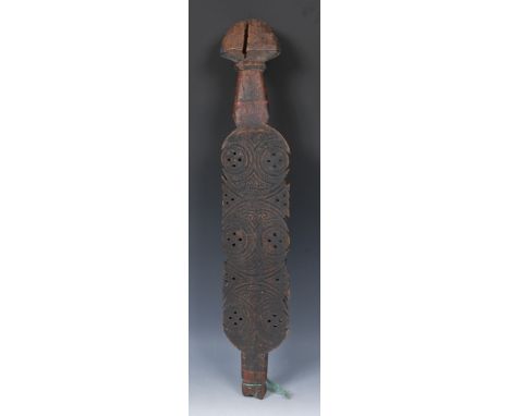 Tribal Art - a Tuareg tent peg, the broad central section shaped, pierced and carved with roundels and geometric motifs, dome