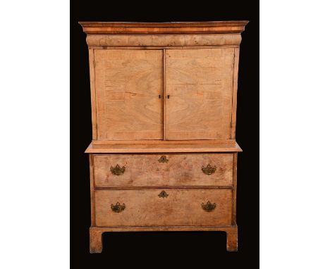 A 'Queen Anne' walnut cabinet on chest, outswept cornice above a cushion moulded frieze drawer, rectangular doors enclosing a