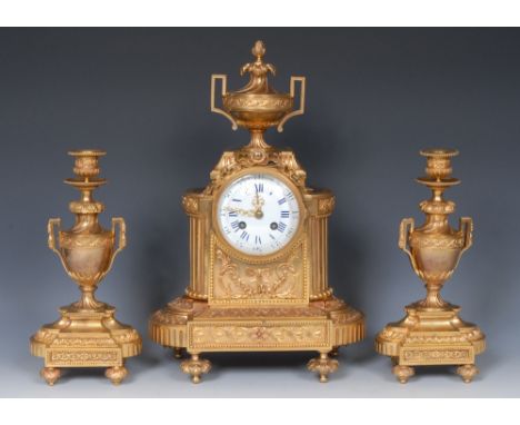 A 19th century French gilt metal clock garniture, 9.5cm convex enamel dial inscribed with Roman and subsidiary Arabic numeral