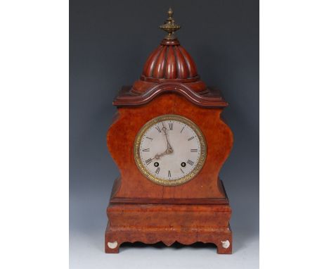 A late 19th century mantel clock, the 14cm silvered dial with Roman numerals, twin winding holes, eight day movement striking