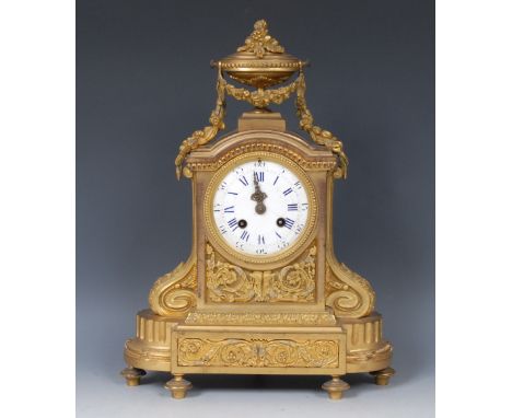 A French gilt brass mantel clock, 9.5cm white enamelled dial, Roman and Arabic numerals, the case with urn finial, with swags