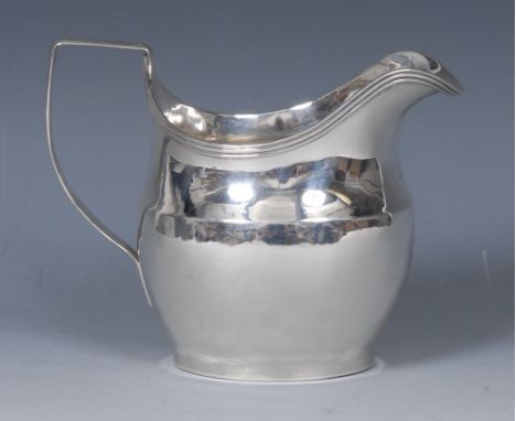 A George III silver helmet shaped cream jug, quite plain, reeded rim and angular scroll handle,12cm long, John Merry, London 