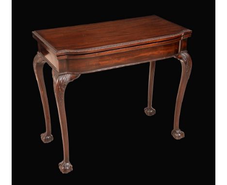 A George II style mahogany bow fronted card table, folding top carved with a lotus border, enclosing an inset baize lined pla