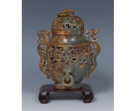 A Chinese jade two-handled panelled vase and cover, carved to recto and verso in relief with a warrior and a mythical beast a