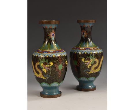 A pair of Chinese cloisonné enamel baluster vases, each decorated in colourful polychrome enamels with a ferocious dragon on 