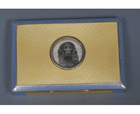 An Austrian silver and enamel rectangular snuff box, hinged cover centred by a portrait miniature of a cocker spaniel, engine