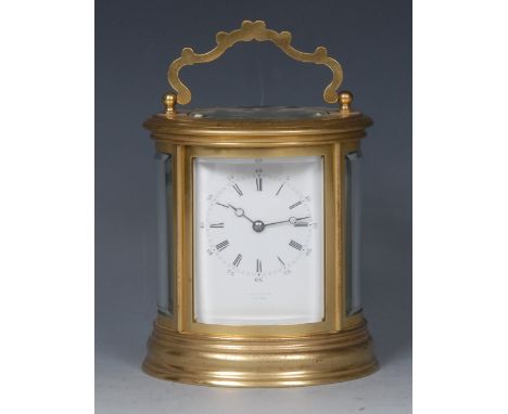 A 20th century oval brass carriage clock,  6.5cm white dial with a chapter of Roman and subsidiary Arabic numerals, the case 