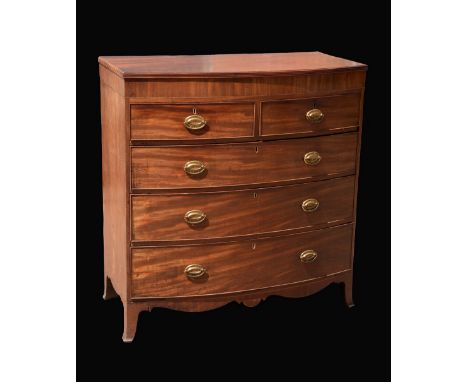 A George III mahogany bow front chest of two short over three long graduated drawers, outlined throughout with boxwood and eb