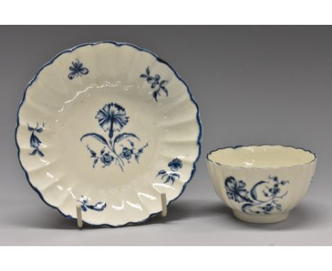 A Worcester Gilliflower pattern fluted tea bowl and saucer, transfer printed in underglaze blue, crescent mark, c.1780