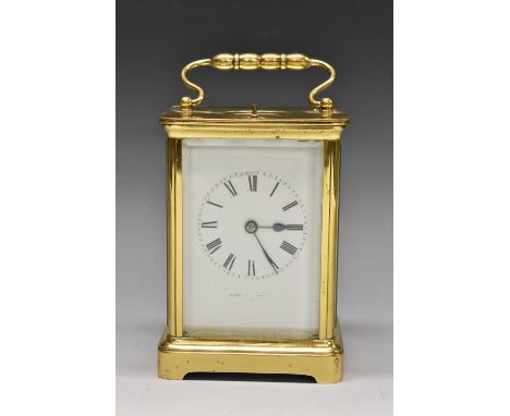 A late 19th century French gilt brass repeating carriage clock, 6.5cm white dial with Roman numerals, striking on a gong, gor