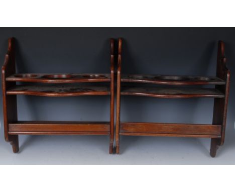 A pair of 19th century mahogany wall mounted tantalus shelves, possibly from a ship's cabin, each serpentine upper tier with 