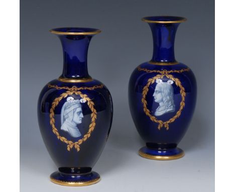 A pair of Kerr and Binns Worcester pate-sur-pate baluster vases, applied in white with portrait busts of Milton and companion