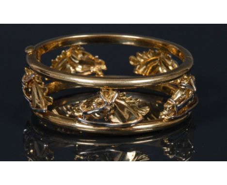 An Italian 18ct gold horse head hinge bangle, twin tubular bar sides joined by five cast horse head masks and two spiralled s