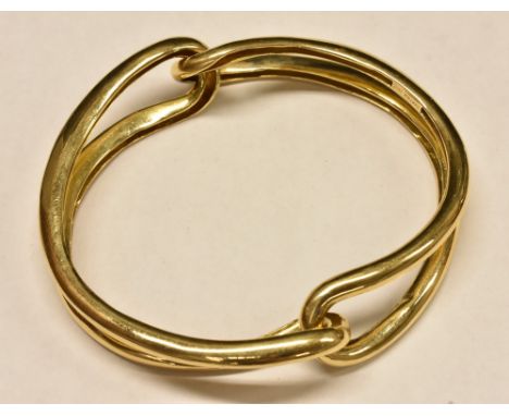 A yellow metal interconnected compression action bangle, stamped Cartier 18k, 69.3g  