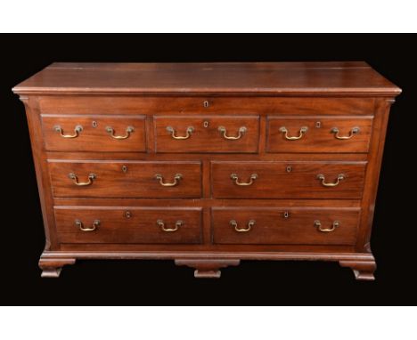 A George III Lancaster chest, hinged top above three blind and four moulded drawers, brass swan neck handles, canted angles o