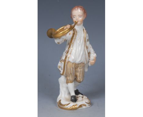 A Derby figure, of a boy standing playing a French horn, wearing long jacket and breeches, picked out in gilt, shaped base, 1