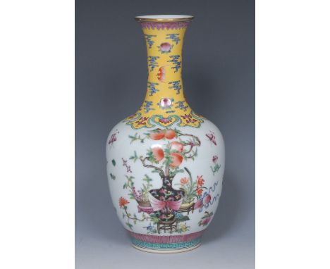 A Chinese Famille Rose bottle vase, decorated with peach bush, insects and precious objects, the neck with bats and peaches o