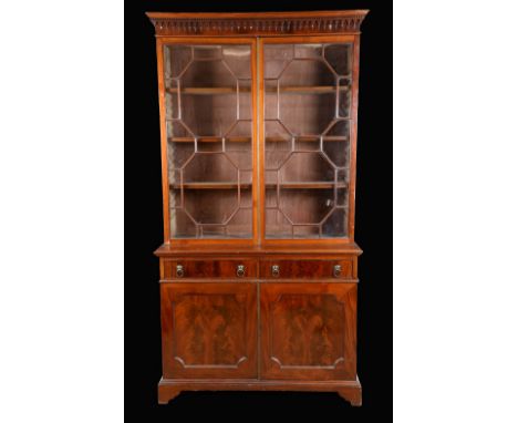 A late Victorian mahogany library bookcase, of George III design, dentil cornice applied with split turned pendants, above a 