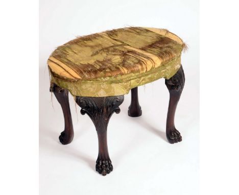 A 19th century Irish mahogany oval stool, stuffed over upholstery, cabriole legs carved with acanthus, lion paw feet, warehou