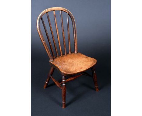 A 19th century elm child's stick back chair, saddle seat, turned legs, H-stretchers, 62cm high, c.1840 (formerly an armchair)