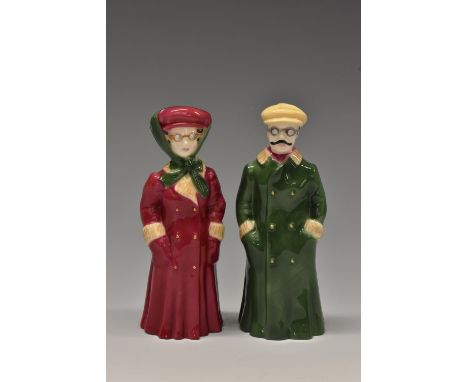 A pair of  Royal Worcester candlesnuffers, The Motorist and Lady Motorist, he wearing a green overcoat, she maroon, 10.5cm hi