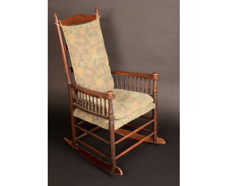 An Arts and Crafts mahogany ladder back rocking chair, in the manner of Liberty, broad arms with spindle galleries, bowed str