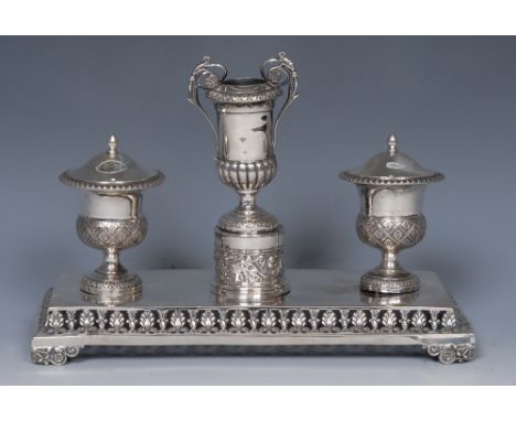 A 19th century Italian silver rectangular inkstand, campana shaped wells, pierced and embossed with a border of anthemions an