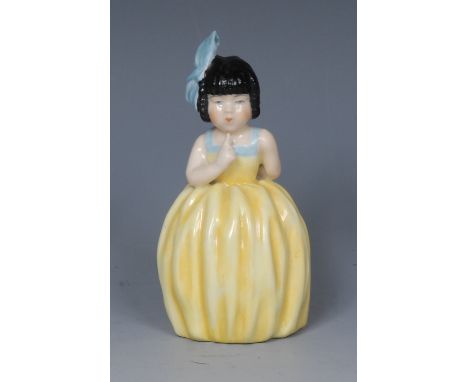 A  Royal Worcester candle snuffer, Hush, modelled with a girl with her index finger held to her mouth, wearing a yellow and b