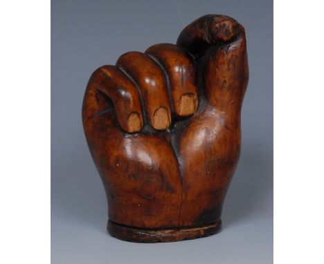 A 19th century fruitwood novelty pinch-of-snuff snuff box, carved as a hand clenched in a pinch, waffle carved oval hinged co