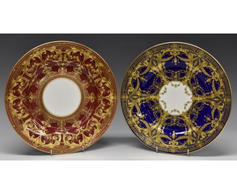 A Royal Worcester circular plates, decorated in raised gilt with scrolls on a cobalt blue ground, 26.5cm diam, printed mark i
