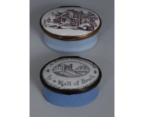 A South Staffordshire enamel oval patch box, the cover enamelled in sepia with rustic cottage, light blue sides, 4.5cm wide, 